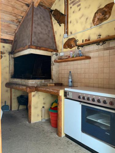 a kitchen with a stove and a white oven at Cabana Barbu in Făgăraş