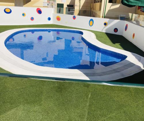 an indoor pool with a slide in a building at Amazing Complex Costa Adeje Pool view & Relax in Adeje