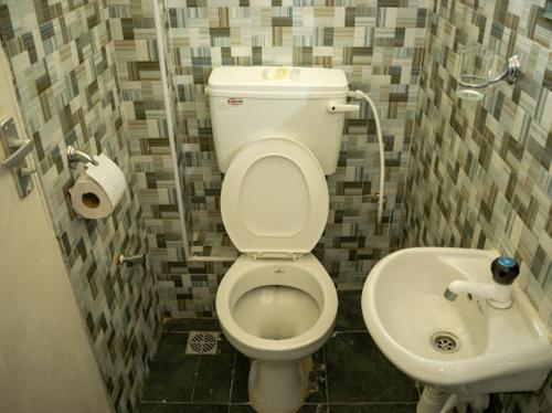 a bathroom with a toilet and a sink at Inkaba Resort & Conference Centre Kilifi in Kilifi