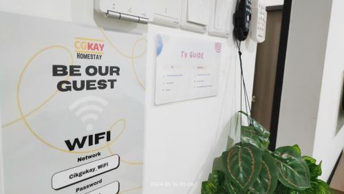 a white refrigerator with a sign that says be our guest at Cikgukay Desaru Homestay Apartment With Pool View WiFi & Netflix in Bandar Penawar