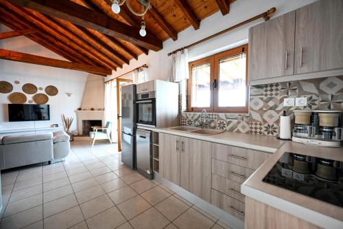 a kitchen with wooden cabinets and a stove top oven at Villa Lazareta in Punta