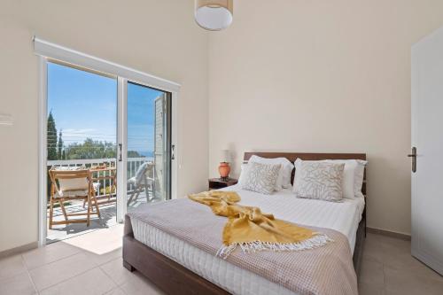 a bedroom with a bed and a balcony at Orange Bliss Townhouse by Nomads in Peyia