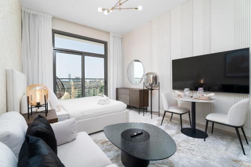 a living room with a white couch and a table at Nasma Luxury Stays - Laya Heights in Dubai