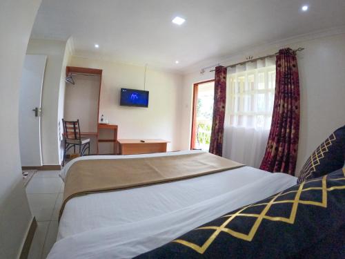 Postel nebo postele na pokoji v ubytování Mayas Suites
