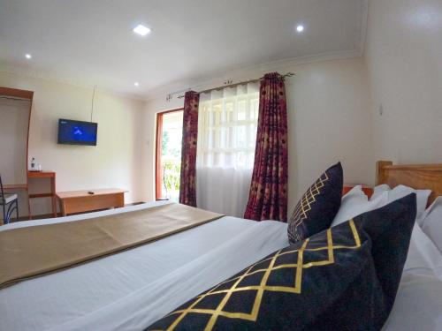 Postel nebo postele na pokoji v ubytování Mayas Suites