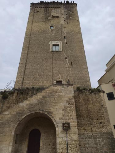 a tall brick tower with a window on top of it at A Casa di Simo in Leverano