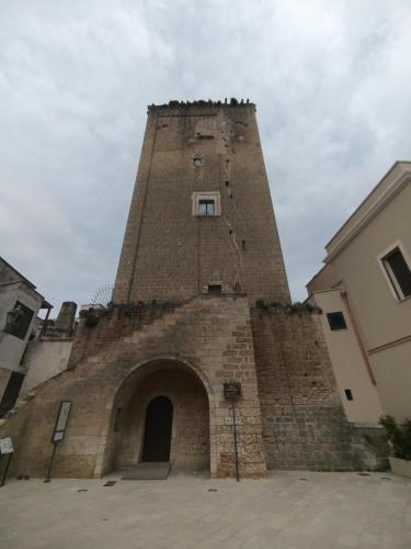 a tall brick tower with a door in a building at A Casa di Simo in Leverano