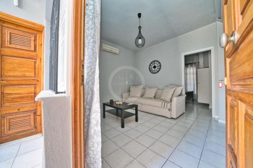 a living room with a couch and a table at Ira Apartment in Ermioni