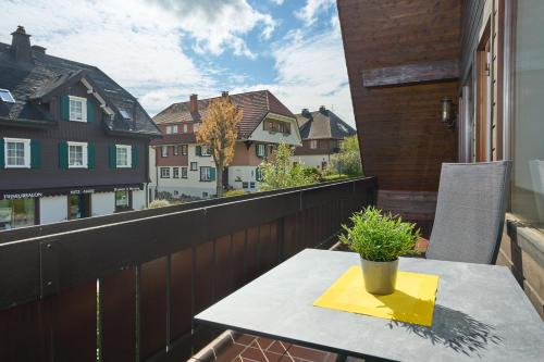 a table with a plant on a balcony at Ferienhaus Unmüßig in Hinterzarten