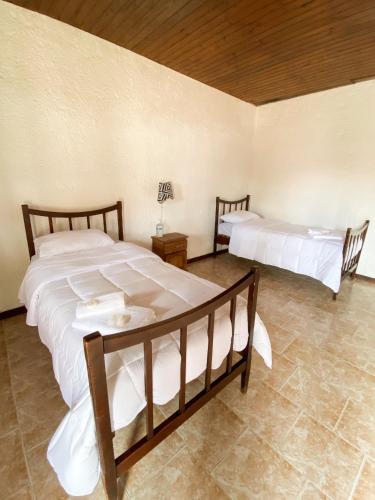 a bedroom with two beds in a room at Posada TyM in Trinidad