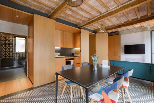 a dining room with a black table and chairs at The View - Sunset & Relax - Suite - Appartamenti Vista Lago in Passignano sul Trasimeno