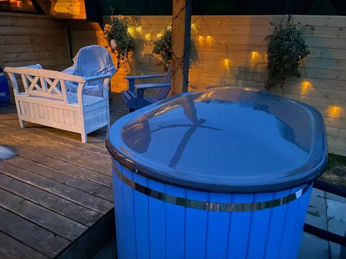 a blue trash can sitting on a deck with a chair at Bieszczadzka Samotnia in Cisna