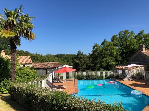 a swimming pool in a yard with a fence at Gîte Chêne Vert in Lolme