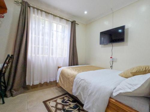 Postel nebo postele na pokoji v ubytování Mayas Suites