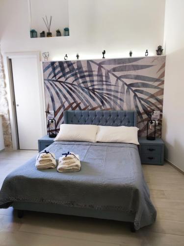 a bedroom with a bed with two towels on it at Maison Divino in Trani