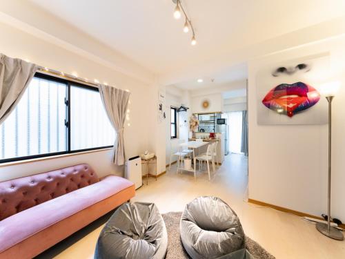 a living room with a couch and a large window at Shinjuku Area, Hatsudai 7min walk, PS5 , Switch , Free Wi-Fi , PocketWi-Fi in Tokyo