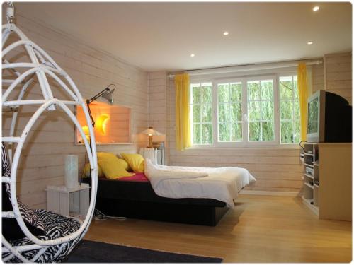 a bedroom with a bed and a large window at Villa Roma in Montluçon