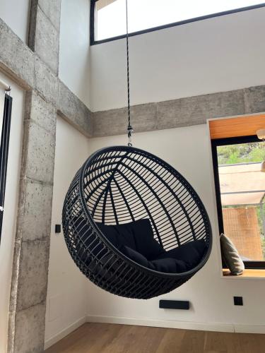 a hanging hammock chair in a room with a window at Casa Encina in Murcia