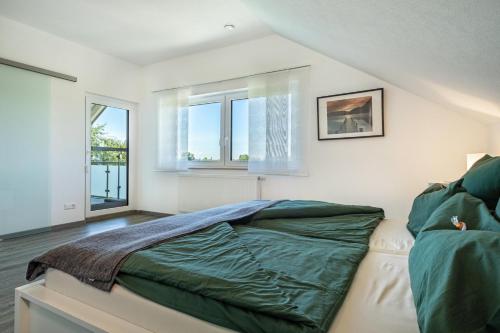 a bedroom with a bed and two windows at Haus Sohl 2 in Friedrichshafen