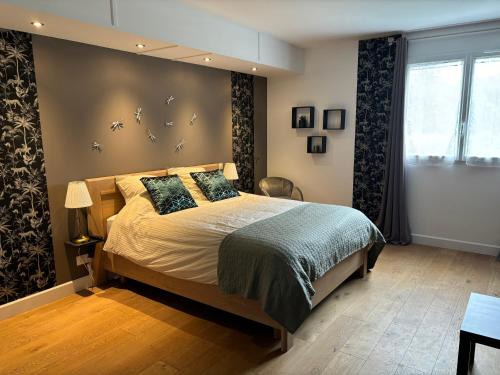 a bedroom with a large bed and a window at Les deux piliers in Courthiézy