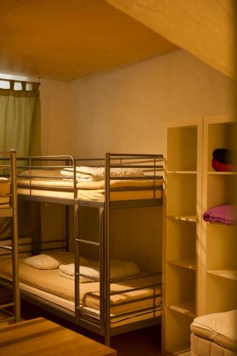 a bunk bed room with three bunk beds in it at Dockside Hostel in Stockholm
