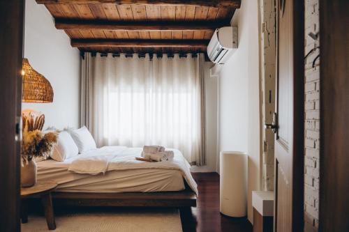 a bedroom with a bed with a large window at 神隱之月 Twilight Moon in Jiufen