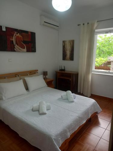 a bedroom with a bed with two towels on it at Goni Guest House in Sarandë