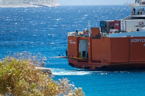 a large red boat floating in the water at Folegandros residence/Karavostasi in Karavostasi