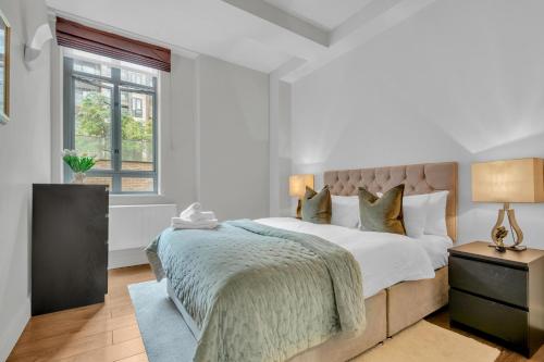 Säng eller sängar i ett rum på London City Road One & Two Bedroom Apartments
