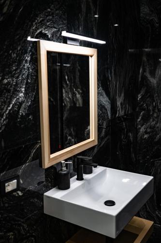 a bathroom sink with a mirror on top of it at Middle Town Palace in Tropea