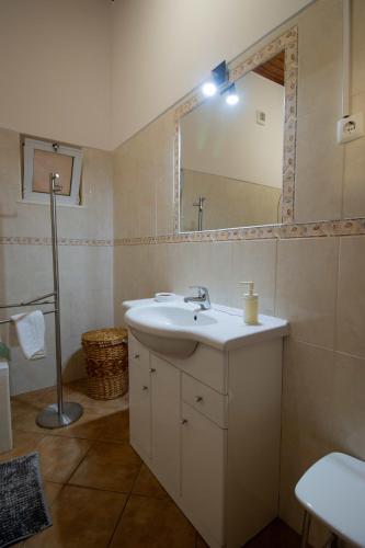 a bathroom with a sink and a mirror at Casa Amarela by Urban Beach Rentals in Carvoeiro