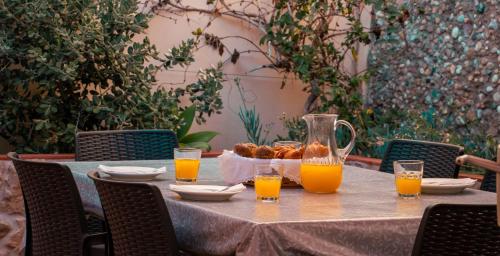 a table with orange juice and a basket of food at Urban Beach - Casa Amarela in Carvoeiro