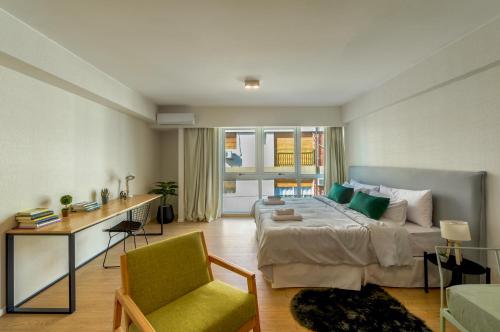 a bedroom with a bed and a desk and a chair at Fliphaus Be Libertador - Lux 4 Pax Loft 13-18 in Buenos Aires