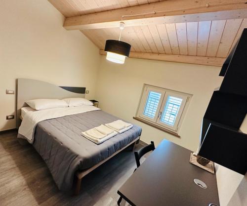 a bedroom with a bed and a desk and a table at Locazione Turistica Rania in Capannori