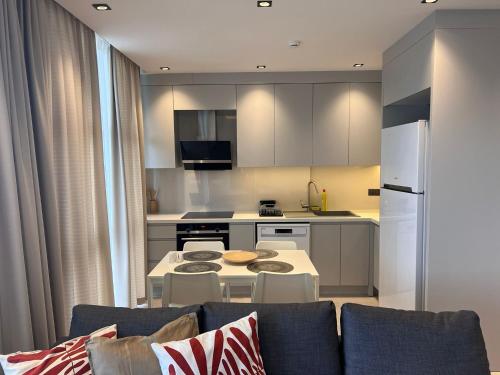 a kitchen with a couch and a table in a room at Ulu Panorama Residence in Alanya