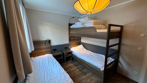two bunk beds in a room with a light at Exclusive Panorama Spa Suiten DAS SCHILLER in Bad Gastein