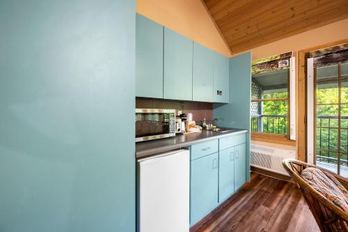 a kitchen with blue cabinets and a counter at Carr's Northside Hotel and Cottages in Gatlinburg