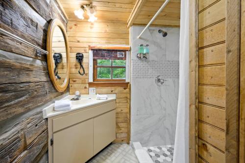a bathroom with a sink and a shower at Carr's Northside Hotel and Cottages in Gatlinburg