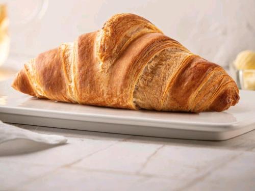 a loaf of bread on a plate on a table at Maison Divino in Trani