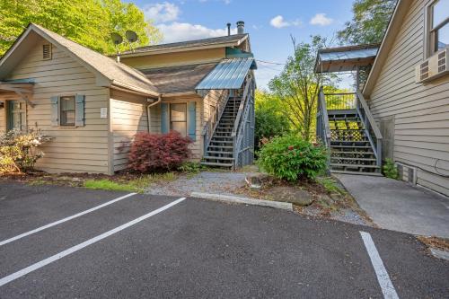 a house with a parking lot in front of it at Carr's Northside Hotel and Cottages in Gatlinburg