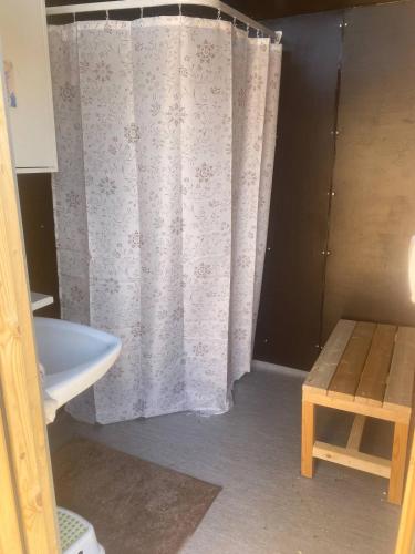 a bathroom with a shower curtain and a sink at Family Skylight in Laitila
