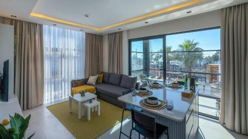a living room with a couch and a table at Ulu Panorama Residence in Alanya