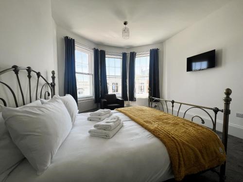 a bedroom with a bed with towels on it at George Street House in Ryde