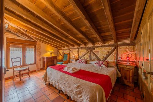 a bedroom with a large bed in a room at Los Lebreles Namaste I y II, desconecta en las Hoces del Duratón in Hinojosas del Cerro