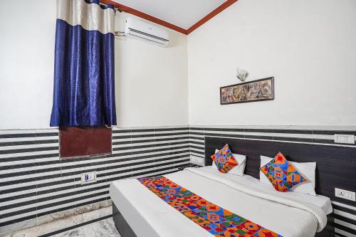 a bedroom with two beds and a window at FabHotel Sarwan in Agra