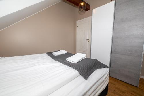 a bedroom with a bed with two towels on it at Bjarnabúð in Húsavík