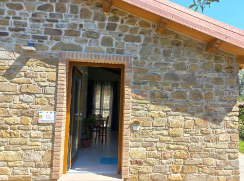 a stone house with a door leading to a patio at Villa Nigro in Laureana Cilento