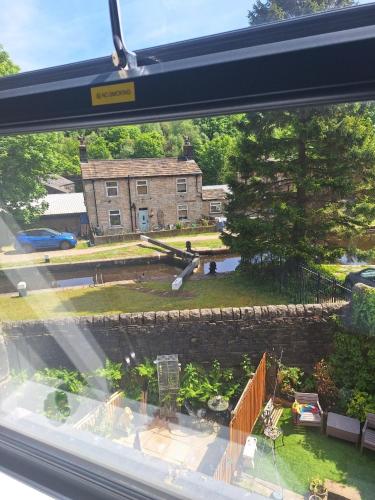 a view of a house from a window at Todmorden Bed & Breakfast - The Toothless Mog in Walsden