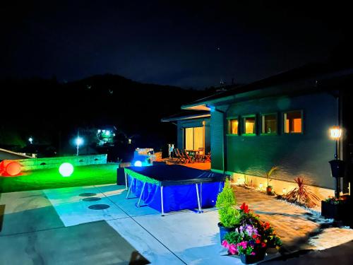 a house with a ping pong table in the yard at night at 村の小さなお宿　おきな in Tosa