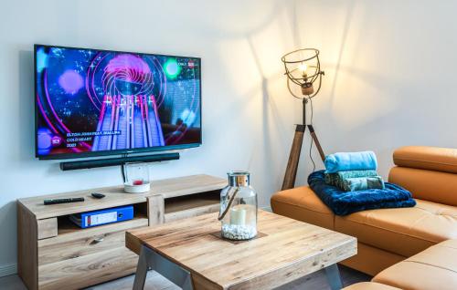 a living room with a television and a coffee table at 4 Bedroom Stunning Home In Jesendorf in Jesendorf